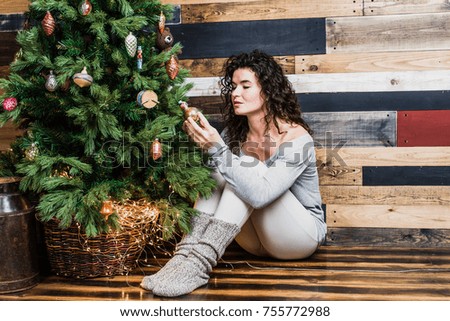 Beautiful woman decorating christmas tree. Christmas and New Year concept