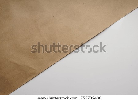Composition of Kraft brown wrapping paper on white. Geometric background. Bright typographic design layout, covers, brochures, business cards, banners. Top view, close-up 