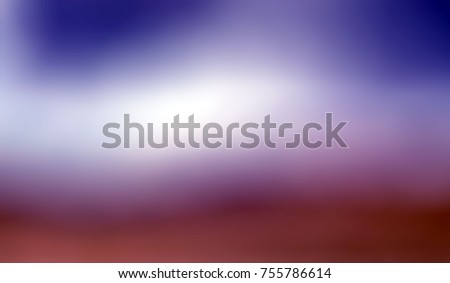Beautiful violet blue cloudy sky blur over chocolate brown desert