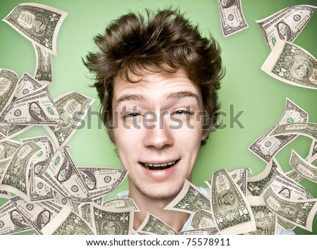 Closeup portrait of a young man with money rain