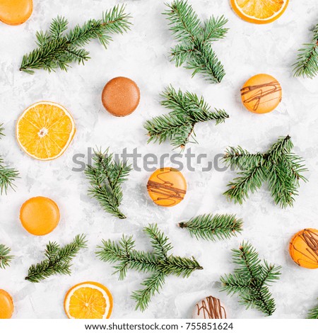 Pattern with oranges, macaroons, chocolate and fir branches on a gray background. flat lay, top view,