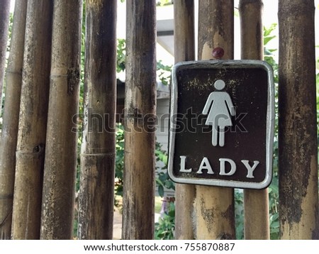 Female bathroom symbol on bamboo