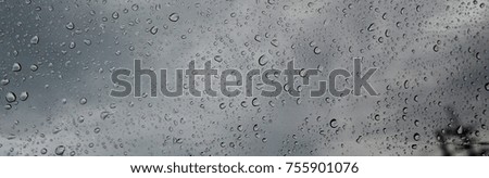 raindrops on window with dark sky