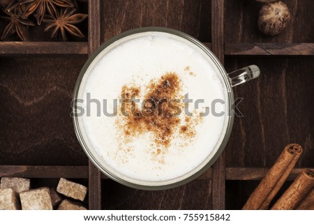 Christmas drink eggnog and ingredients on a green background. Top view