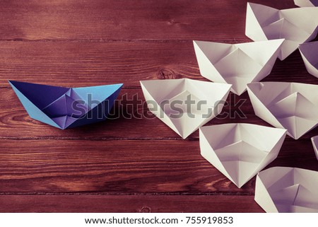 Set of origami boats on wooden table