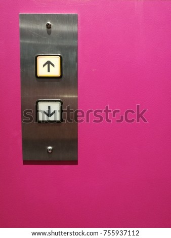 Lift arrow metal pad on pink background. elevator button pad. up and down.