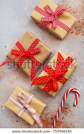 box for present and candy cane on a table