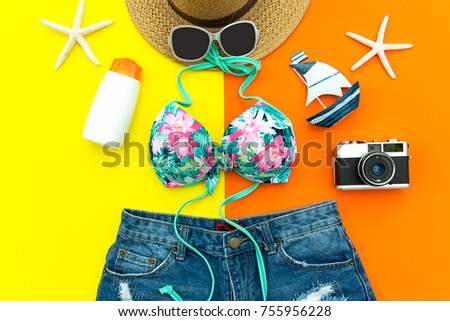 Summer Fashion woman swimsuit Bikini. Tropical travel the sea. Unusual top view, colorful yellow and orange background.  Summer & Travel Concept.