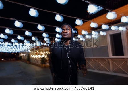 Motion photo with blurred lights and jogger male