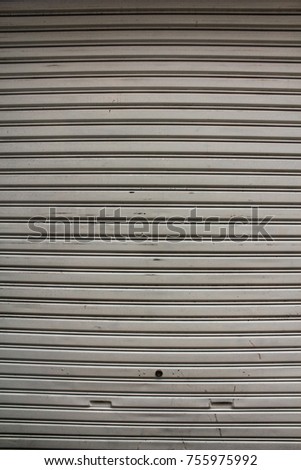 Background of grey rolled steel doors, which are commonly used. Popularly used as a restaurant outlet door.