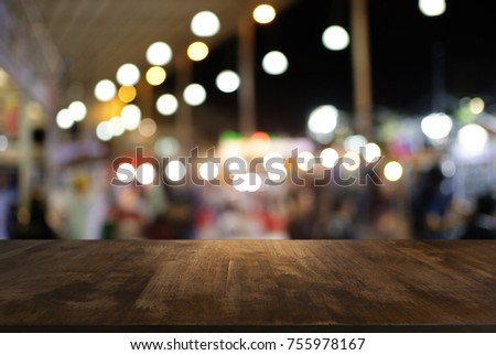 Empty wood table top and blur of night market background/selective focus .For montage product display Royalty-Free Stock Photo #755978167