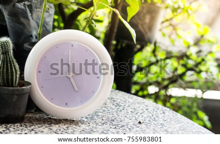 a white clock on the table