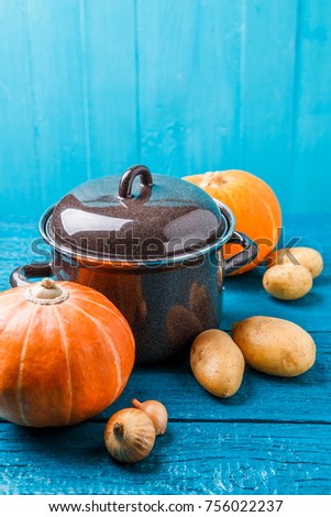 Picture of iron pan with lid, vegetables for soup, potatoes, pumpkins,