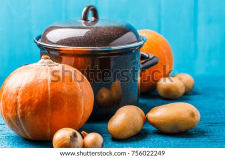 Picture of pot with lid, vegetables, potatoes, pumpkin, onions
