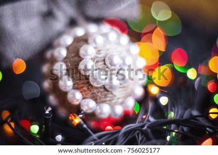 Christmas handmade twine ball and festoon on blurred, sparkling and fairy tree background. Happy New Year and Xmas theme. handmade decor
