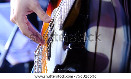 Masterful, masterly game on an electroguitar. Man plays a close up of a hand on an electroguitar