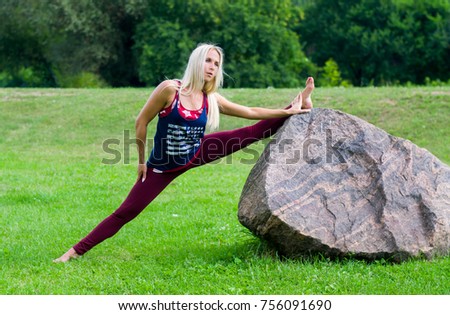 beautiful girl doing yoga outdoors