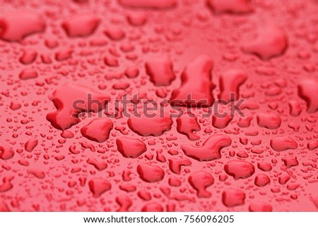 Drops of Rain or Water Drop on the Hood of the Red Car. Rain Drops on the Surface of the Car or on the Iron Surface Flow Down. Abstract Background and Water Texture for Design.