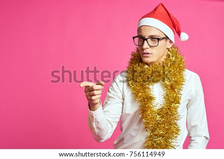 Christmas, business man with a gold tinsel on his head a New Year's cap                               
