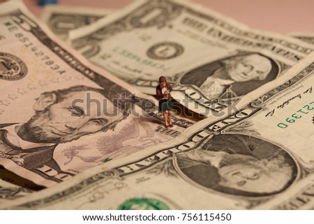 Woman searching for savings or dollars. Bargain seeking or looking for money. Miniature person with magnifying glass looks for higher earnings or lucrative business venture. Idea of how to find money