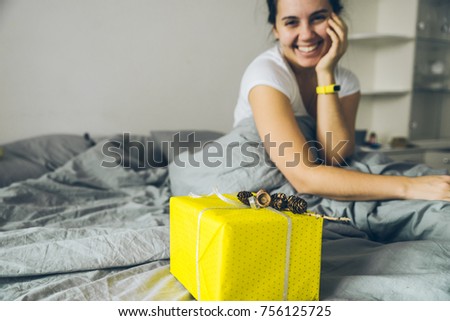 present woman a gift in bed in the morning