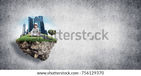 Young little boy keeping eyes closed and looking concentrated while meditating on flying island in the air with gray wall on background. 3D rendering.
