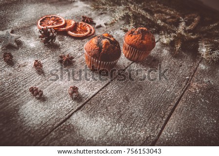 New year composition with holiday decoration - Homemade christmas cupcakes on wooden background with spruce twigs and pinecones. Christmas card. Space for text Vintage style Toned picture by Instagram