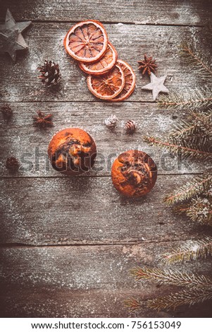 New year composition with holiday decoration - Christmas cupcakes on wooden background with spruce twigs and pinecones. Xmas card. Space for text Vintage style Toned picture by Instagram, Top View