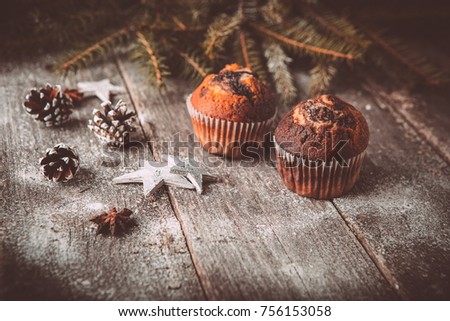 New year composition with holiday decoration - Homemade christmas cupcakes on wooden background with spruce twigs and pinecones. Christmas card. Space for text Vintage style Toned picture by Instagram