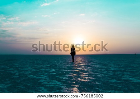 alone girl silhouette at sunset, salt lake of turkey