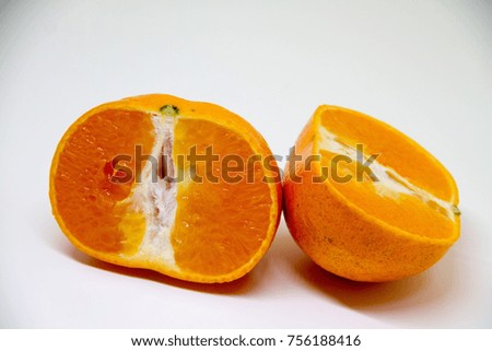 Two halves of orange on white background.