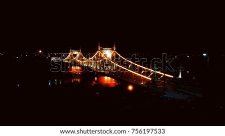 a city illuminated bridge in the night