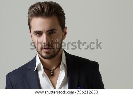 Businessman in suit in the studio on a light gray background Royalty-Free Stock Photo #756212650