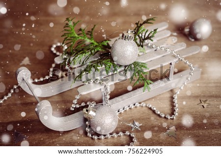 Christmas Composition in Rustic Style. Holidays Background With Wooden Xmas Decoration. Toned image. Snow effect.