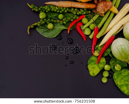 Herb and spicy ingredients for making Thai food on dark background. Recipes book, Thai food or cooking concept, Top view with copy space.