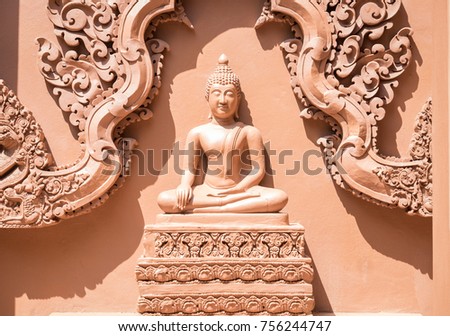 The buddha statue in meditation form sculpture at the temple wall. Thai art scuplture need precise skill from sculptor.
