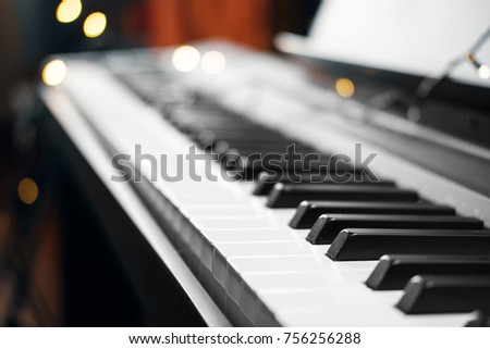piano keys with beautiful small yellow lights bokeh in the background, piano keys with all the Christmas lights, concert, backstage