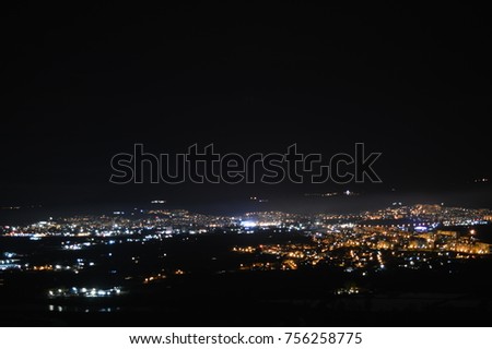 
 night lights of the city on a fog background in the sky and a stunning sensation