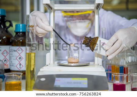 Scientists are using chemicals weighing scales with a digital weighing scales in a laboratory chemicals.