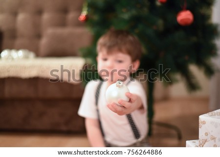 Little boy holds the New Year's decoration