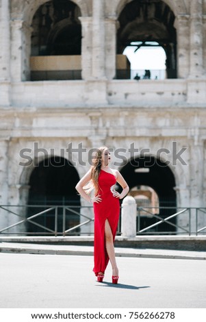 Happy woman in fashion dress travel in Colosseum in Rome, Italy