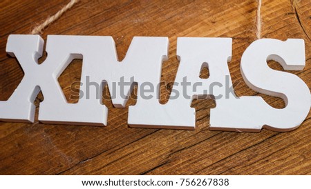 White tag text Xmas hanging on rope wooden background