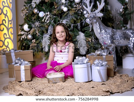 Waiting for the magical Christmas night. A little girl waiting for the new year holiday and Christmas.