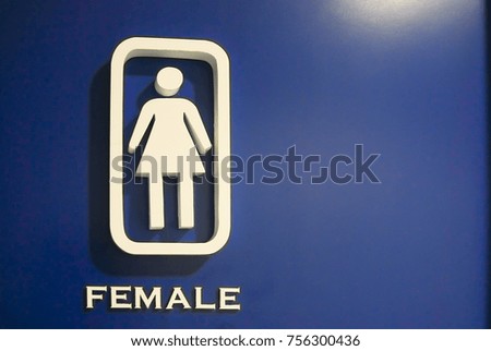 Female toilet symbol on blue board