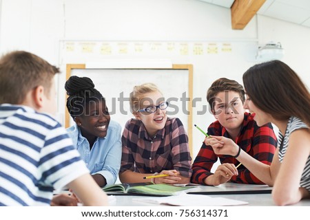 Group Of Teenage Students Collaborating On Project In Classroom Royalty-Free Stock Photo #756314371