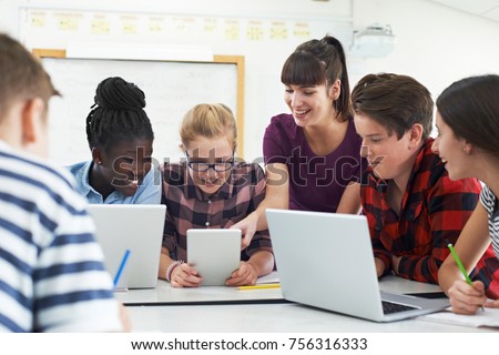 Teenage Students With Teacher In IT Class Royalty-Free Stock Photo #756316333