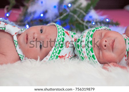 Little newborn baby boys, twin brothers. Christmas costume