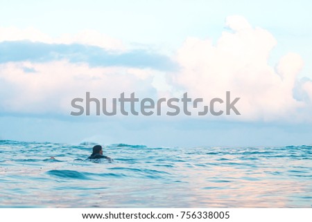 surfer paddle the ocean