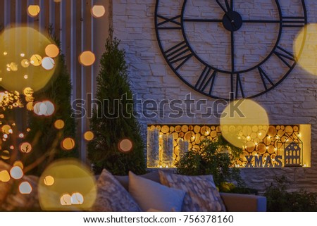 The room is decorated with a Christmas decor with large clock and luminous garlands