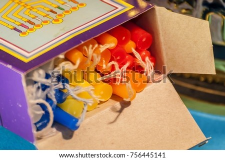 A box with colorful Hanukkah candles. Hanukkah is a Jewish holiday of light that falls usually on December and sometimes coincides with Christmas.